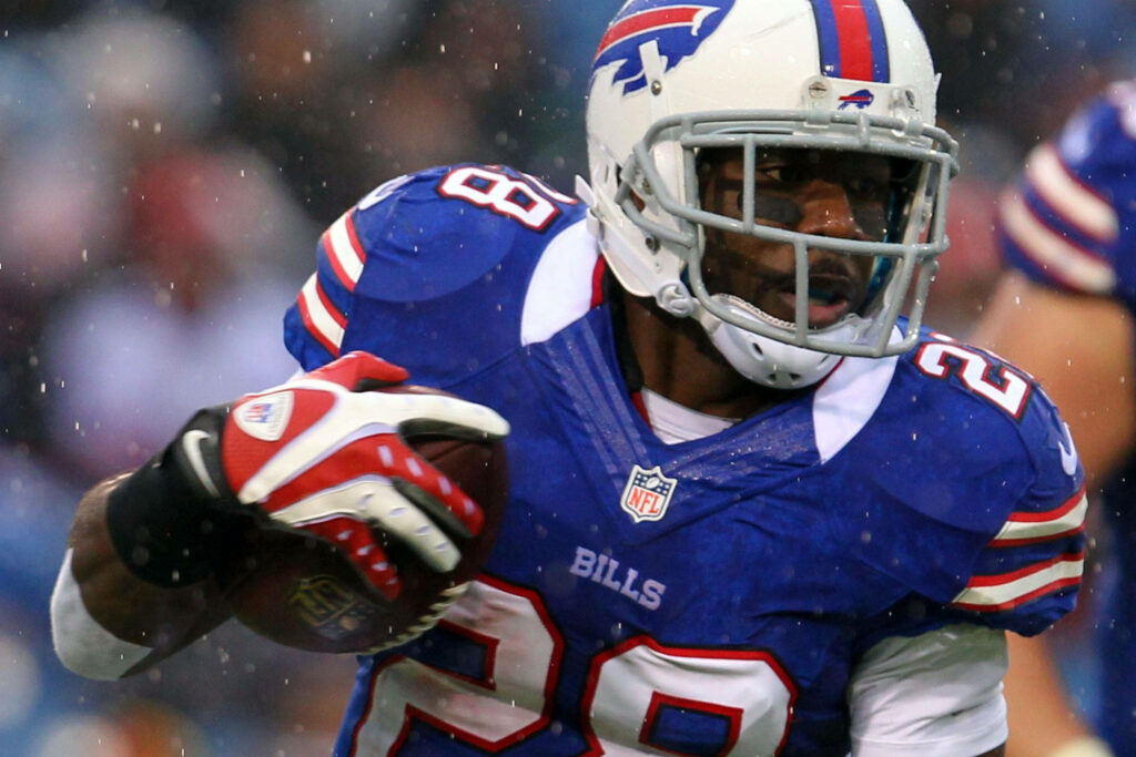 CJ Spiller Buffalo Bills jersey 28 mid-action NFL game vibrant team colors motion blur background Wallpaper