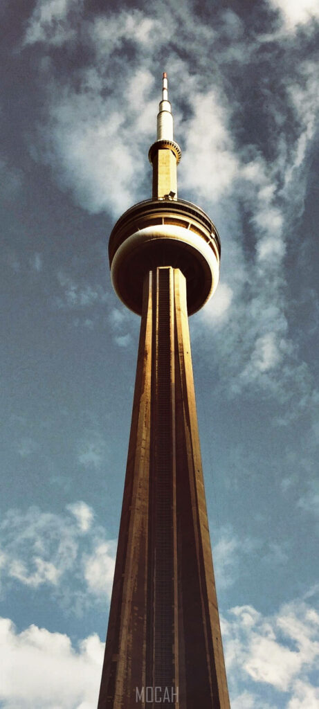 CN Tower wallpaper showcasing architectural height with warm golden tones and cloudy sky background