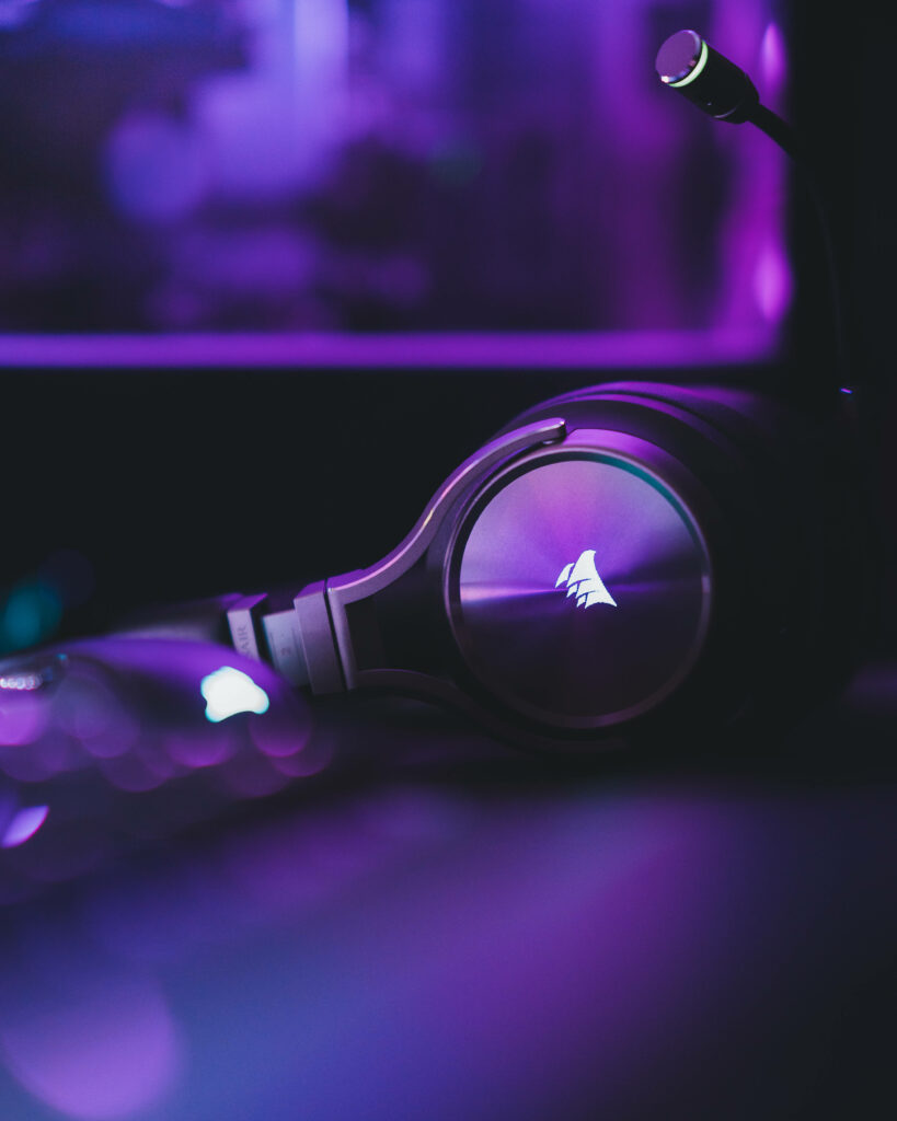 Close-up of CORSAIR gaming headset with black purple design ambient lighting high-tech background Wallpaper