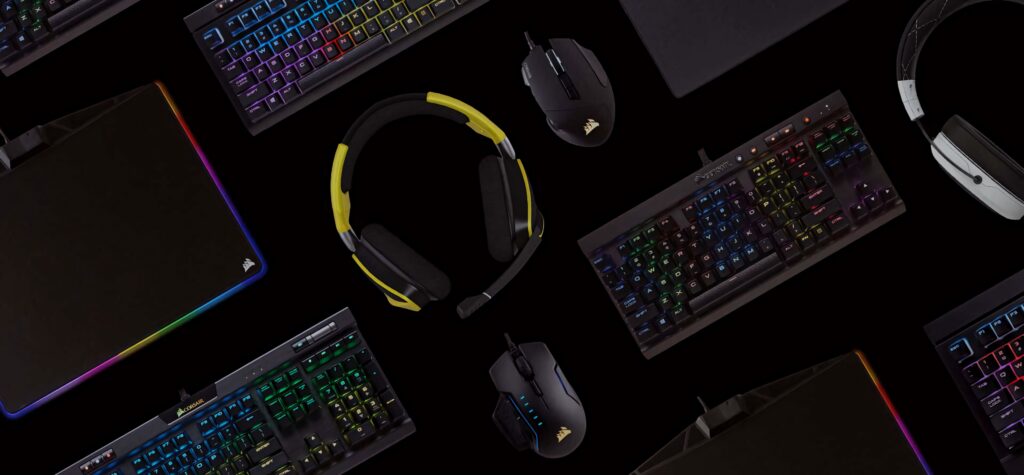 CORSAIR gaming setup with RGB keyboard headset and mice on black background for immersive play Wallpaper