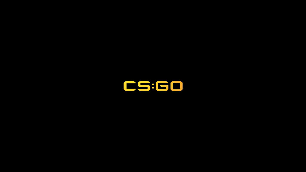 Bold and Striking: CS GO Logo Takes Center Stage in Vibrant Yellow Against Sleek Black Wallpaper
