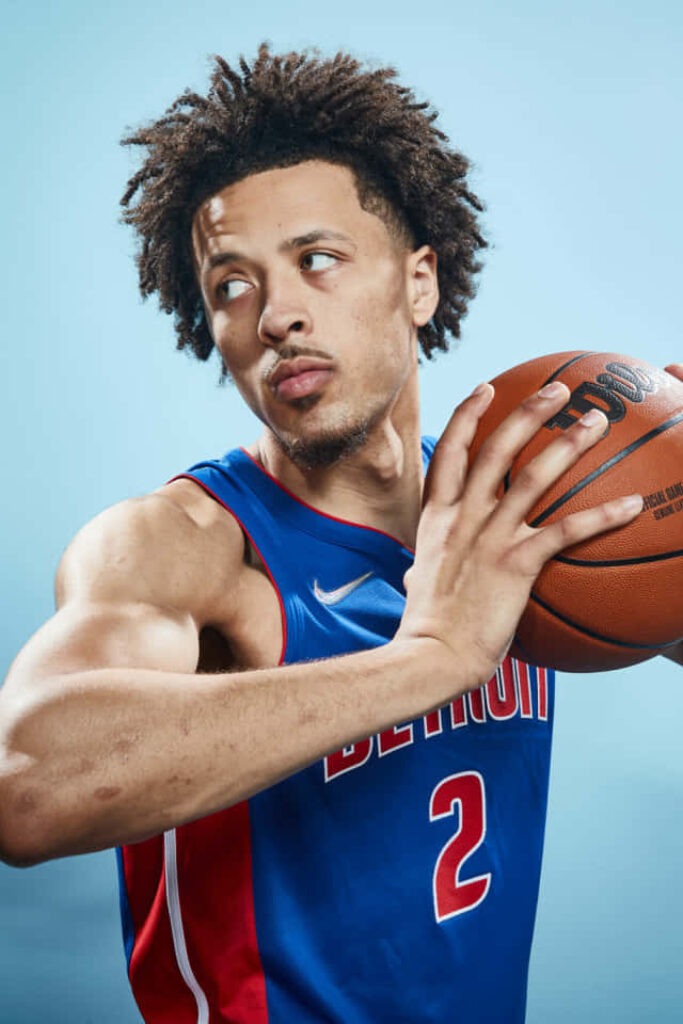 Cade Cunningham Detroit basketball wallpaper focused intense with ball blue NBA background