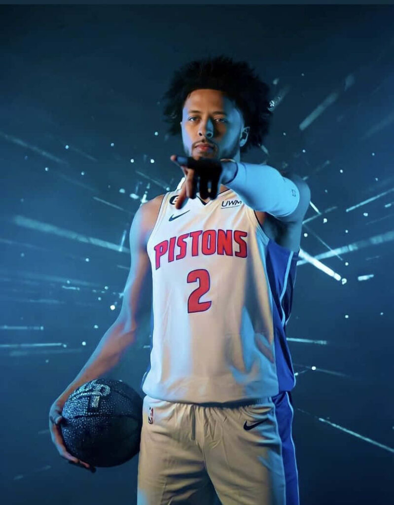 Cade Cunningham Detroit Pistons holding basketball futuristic blue light burst dynamic promo wallpaper