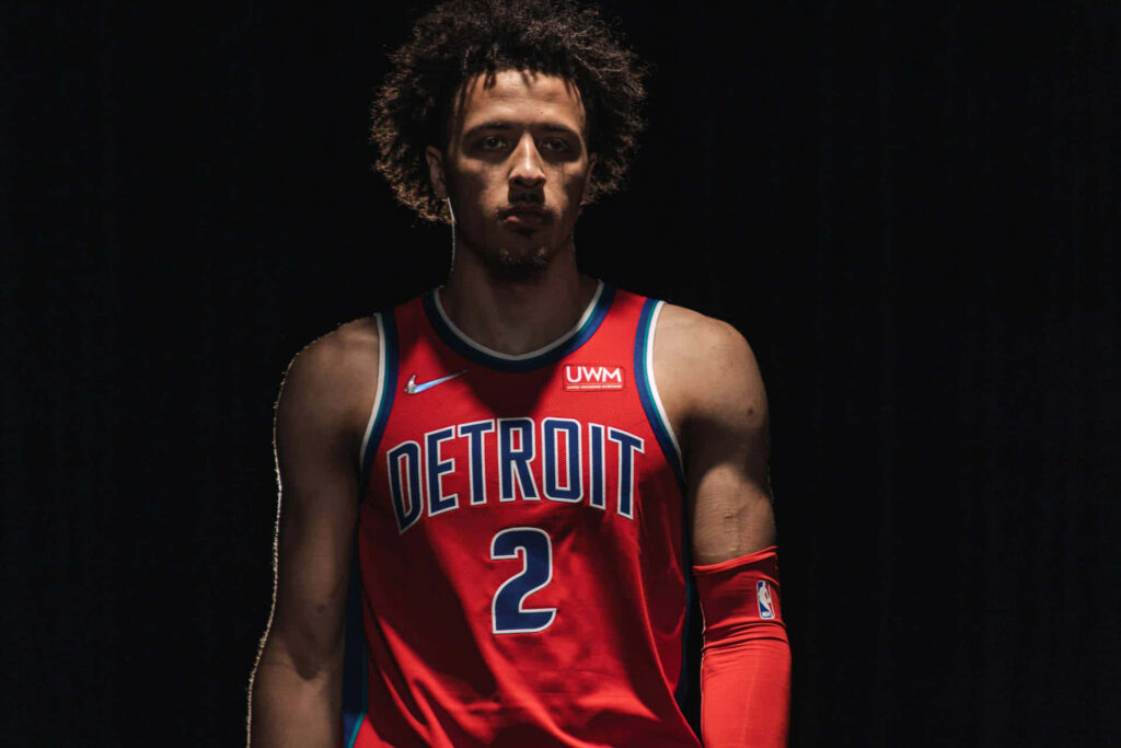 Cade Cunningham Detroit Pistons wallpaper with dramatic lighting highlights intense basketball star pose