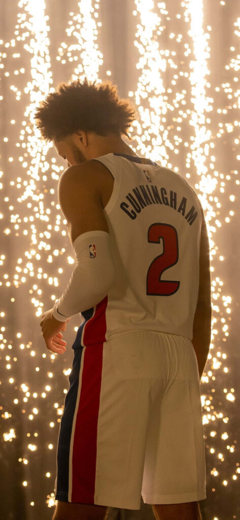 Cade Cunningham in Detroit Pistons uniform with sparkling lights background dynamic wallpaper