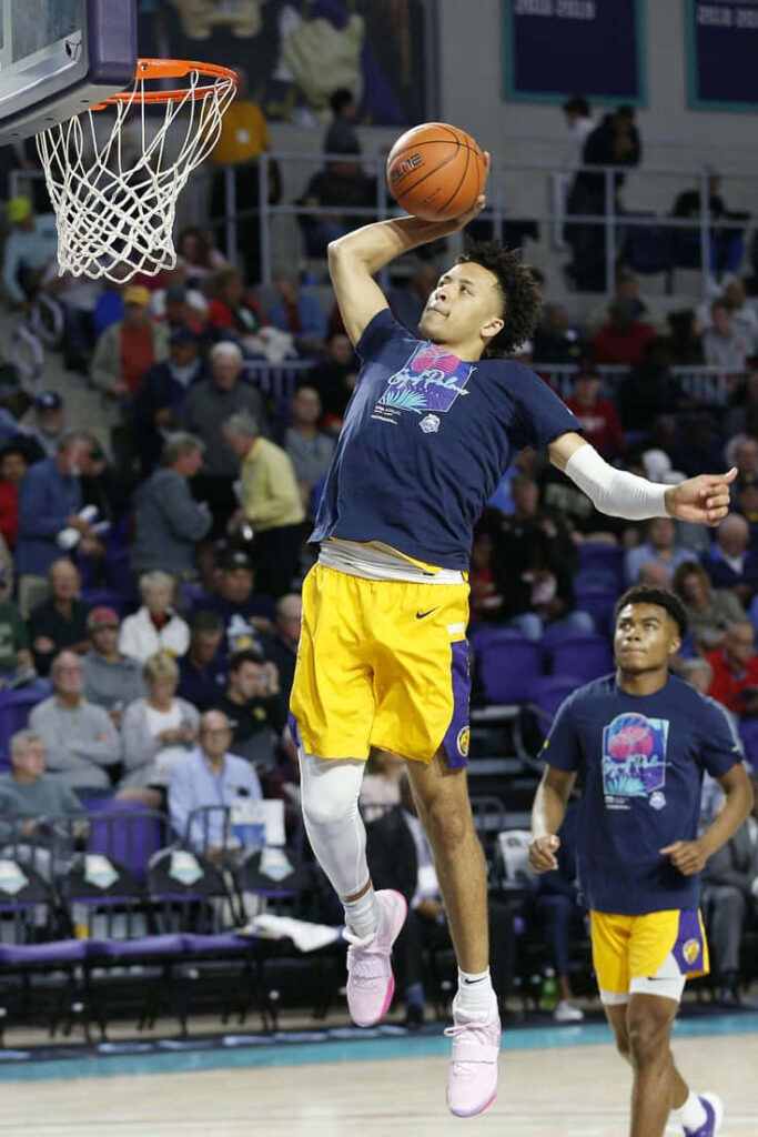 Cade Cunningham mid-air dunk warmup gym vibrant dynamic athletic intense focused pregame Wallpaper
