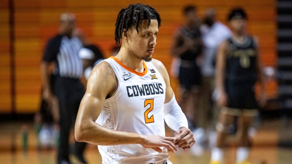 Cade Cunningham in Oklahoma State Cowboys uniform focused intense basketball action wallpaper