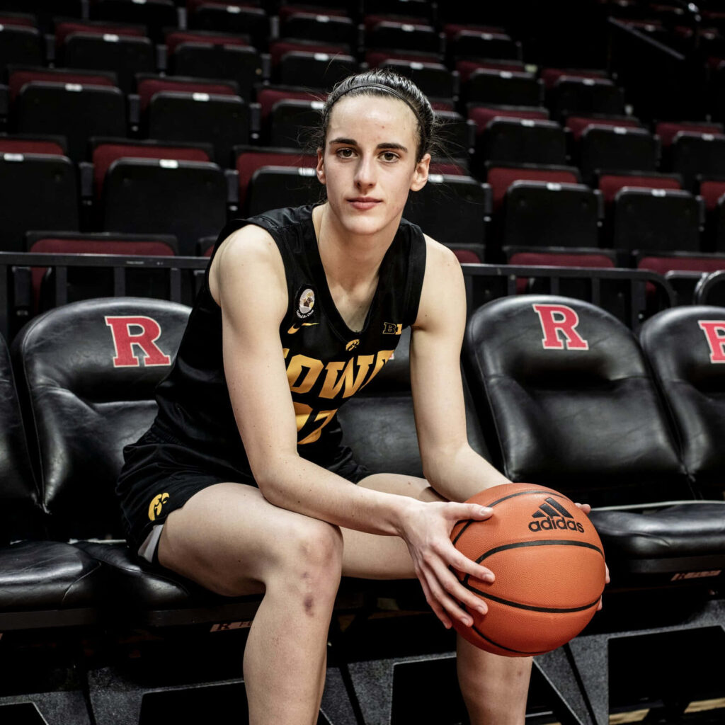 Caitlin Clark Iowa Basketball player courtside holding ball focused determined athlete portrait Wallpaper