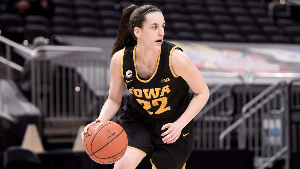 Caitlin Clark dribbling basketball in black Iowa uniform on bright court showing focus and skill Wallpaper