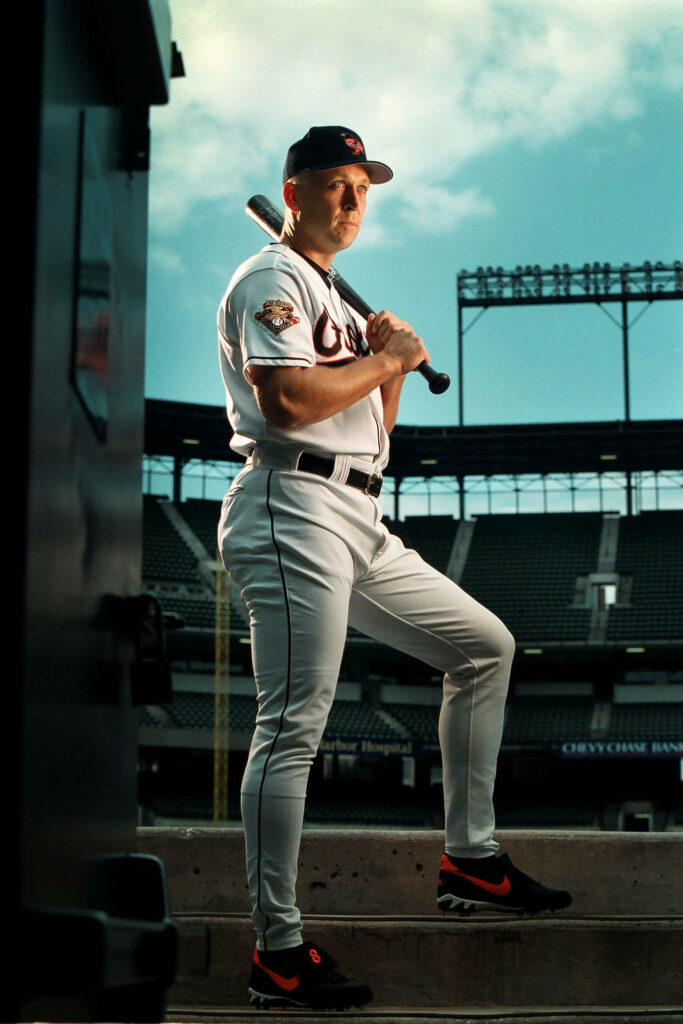 Cal Ripken Jr in Baltimore Orioles uniform with bat in classic baseball stadium vivid colors Wallpaper
