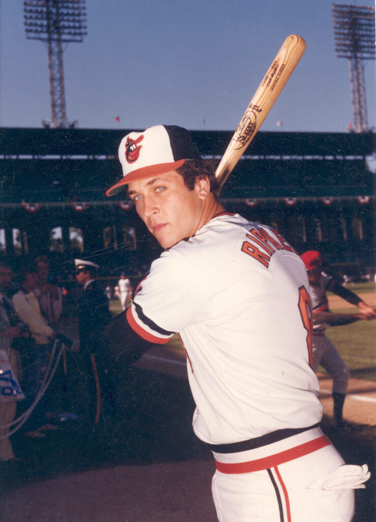 Cal Ripken Jr batting in Baltimore Orioles uniform vintage style sunlit stadium wallpaper background