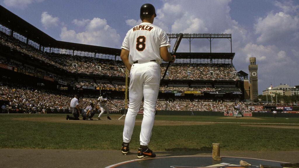 Cal Ripken Jr in number 8 jersey ready to bat on classic baseball field with vibrant stadium crowd Wallpaper