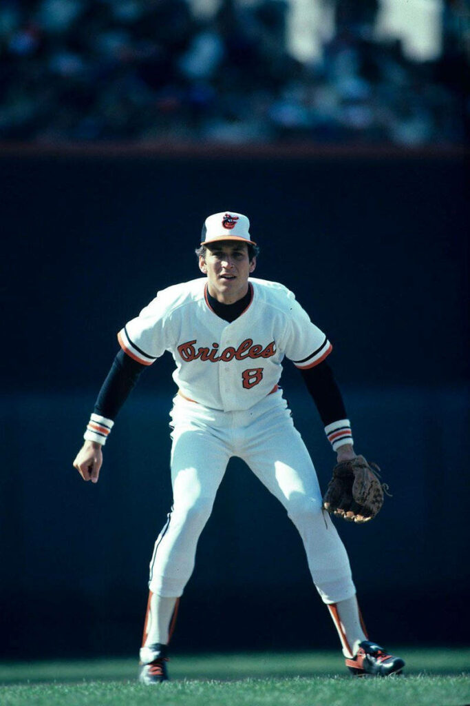 Cal Ripken Jr in white Orioles jersey number 8 intense action vintage baseball stadium wallpaper