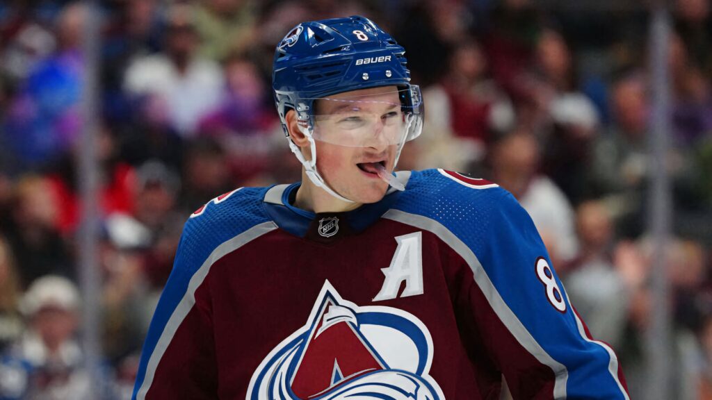 Cale Makar in Colorado Avalanche uniform focused mid-game with vivid arena lighting wallpaper