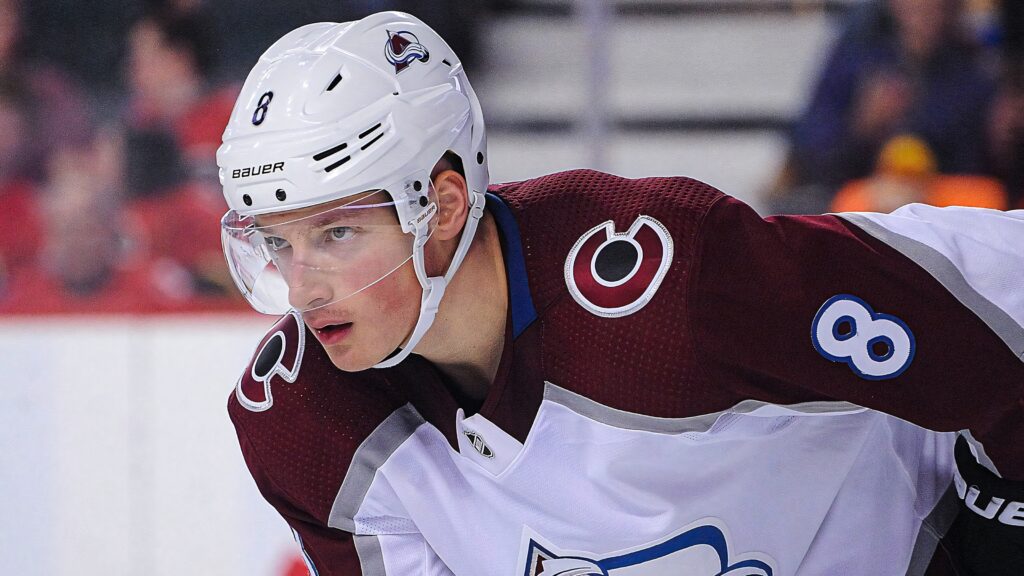 Cale Makar intense focused look Colorado Avalanche jersey crisp competitive ice hockey wallpaper