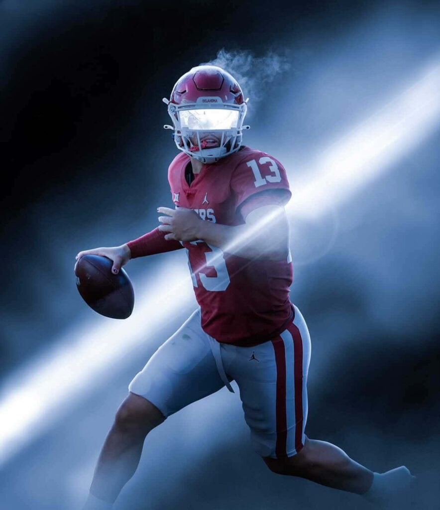 Caleb Williams dynamic quarterback in red uniform mid-motion with dramatic misty blue background Wallpaper
