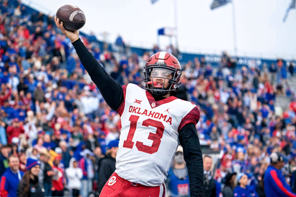 Caleb Williams Oklahoma quarterback throws football in vibrant stadium during college game day action Wallpaper