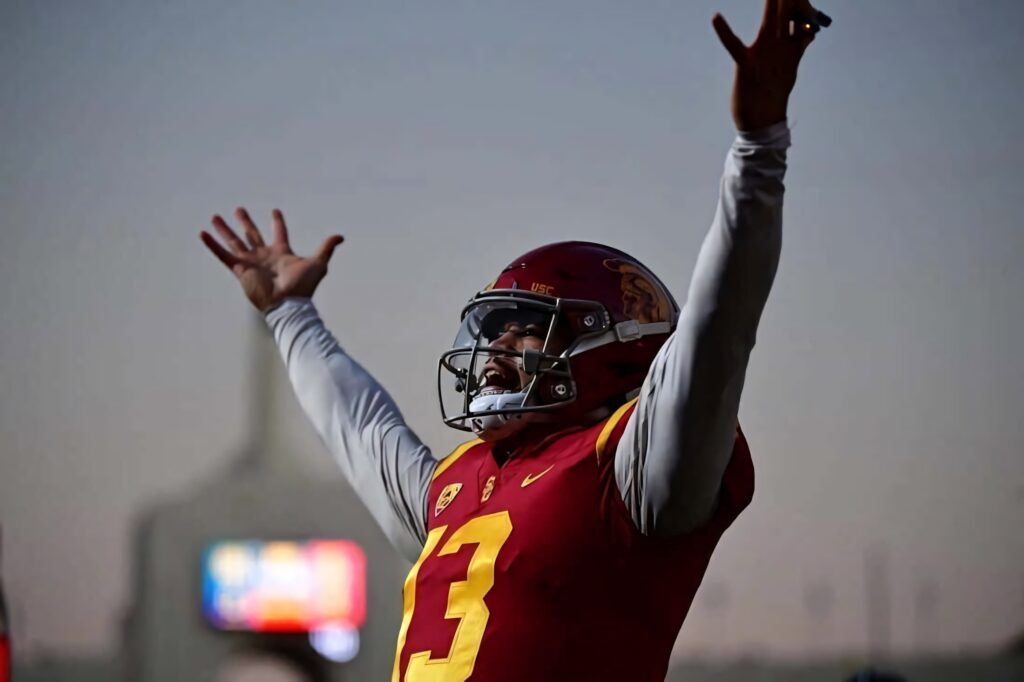 Caleb Williams USC quarterback celebrating in vibrant sunset lighting stadium wallpaper background