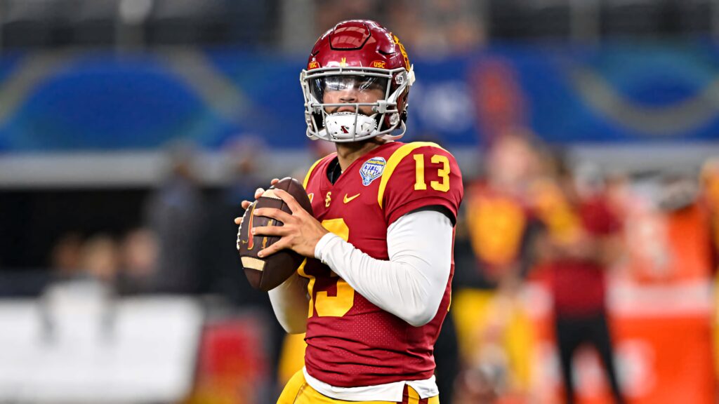 Caleb Williams USC quarterback in cardinal gold uniform ready to throw during intense football game Wallpaper