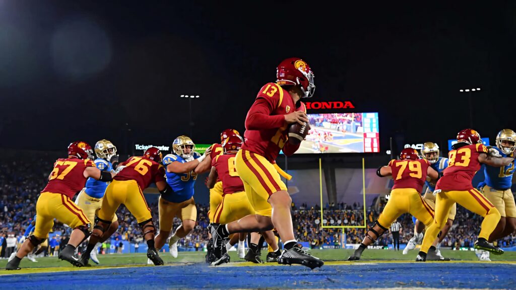 Caleb Williams USC quarterback in action night game vibrant stadium intense football moment Wallpaper