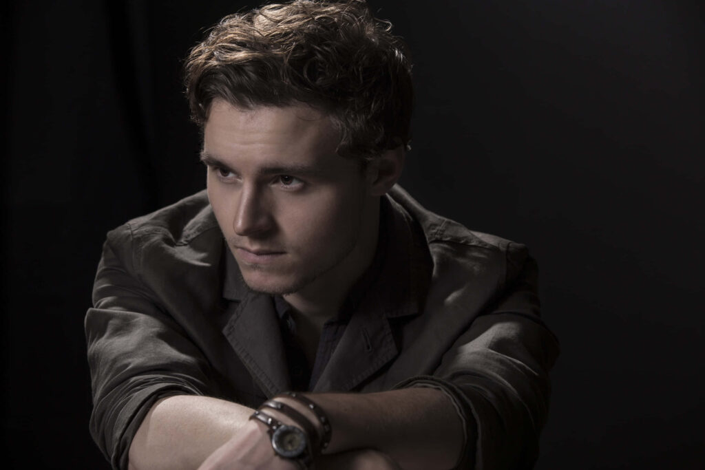 Callan McAuliffe moody portrait wallpaper with soft dramatic lighting and contemplative expression