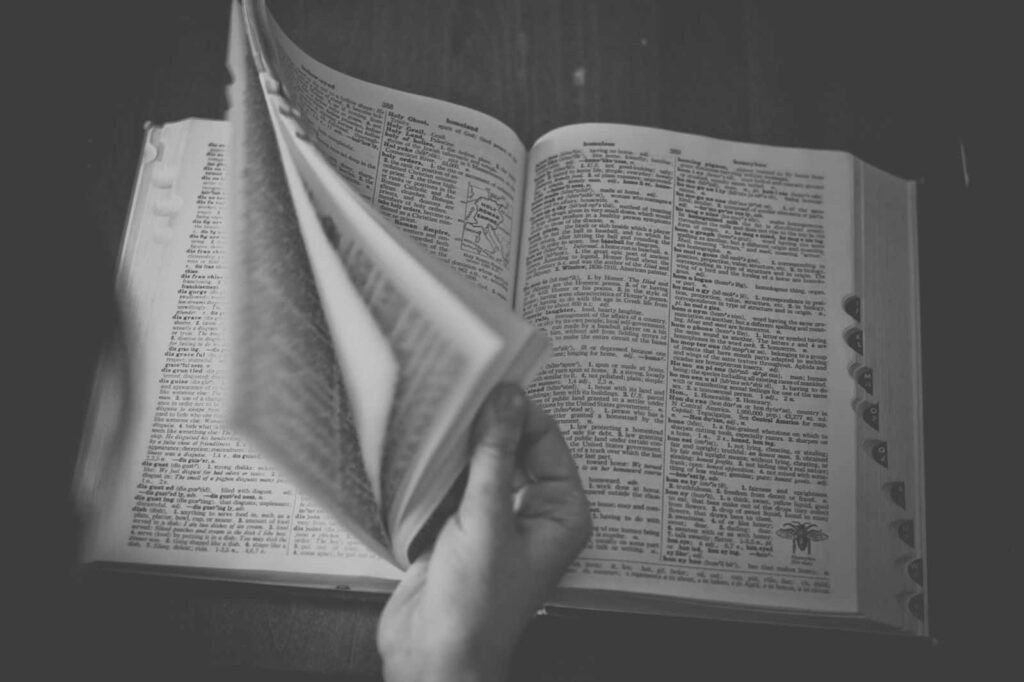Calm Black and White Wallpaper: Open Book on Wooden Table