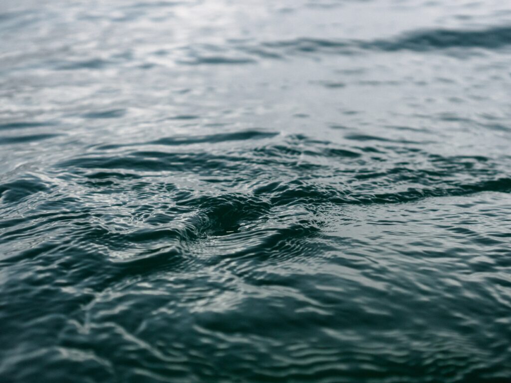 Calming blue water wallpaper with gentle ripples and soft focus creating peaceful serenity