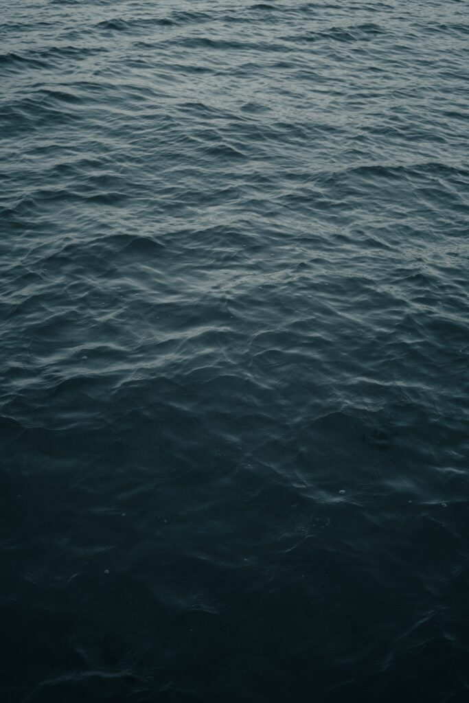 Calm water surface wallpaper with gentle gray waves and ripples for a minimalist backdrop