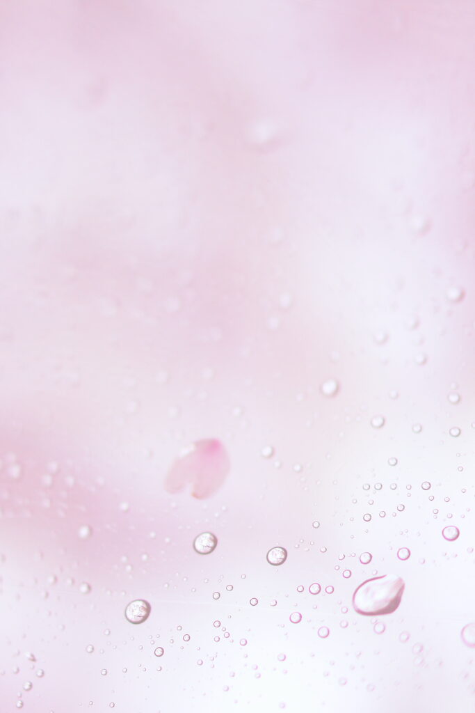 Calm Macros: Clear Water Droplets on Soft Pink Wallpaper Background