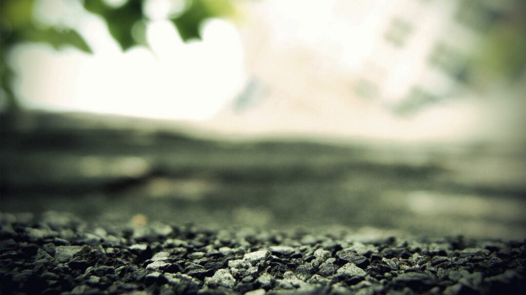Close-up of small gray stones and pebbles with natural texture and soft blurred background Wallpaper