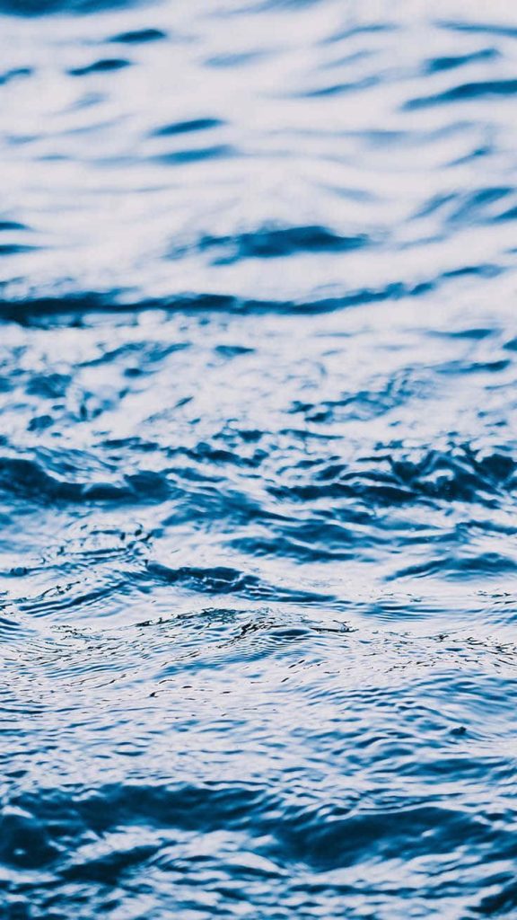 Serene rippling water in deep navy and azure shades minimalist blue wallpaper background for iPhone