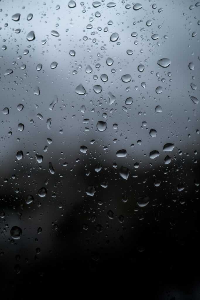 Serene Macro Wallpaper: Water Droplets on Gray Glass Background