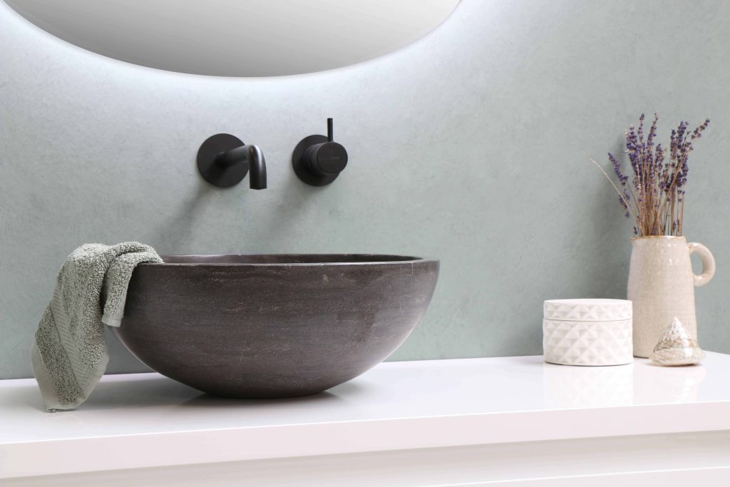 Modern bathroom with stone bowl sink matte black faucet sage green walls and dried lavender Wallpaper