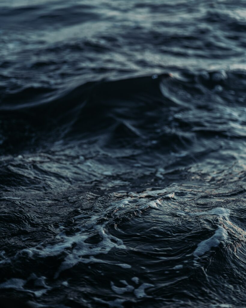 Deep blue ocean wallpaper with textured waves and gentle ripples creating a calming scene