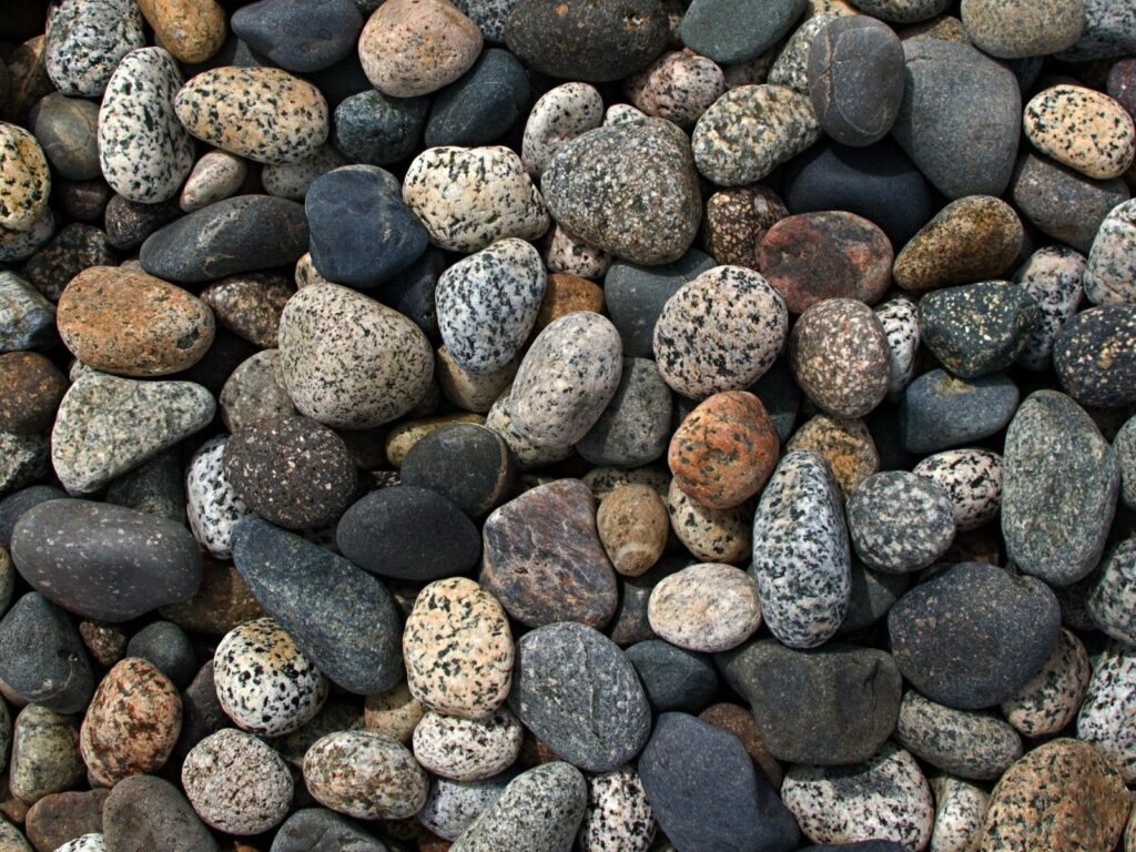 Natural smooth stones wallpaper with earthy colors textures and calming organic patterns background