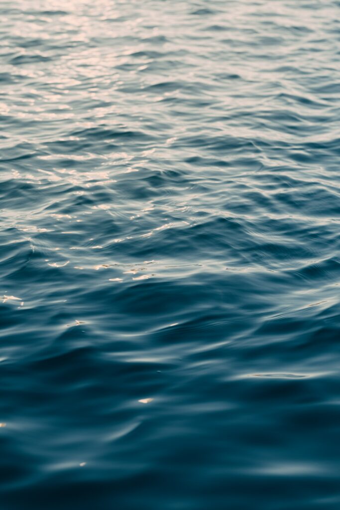 Calming ocean wallpaper with soft focus gentle ripples minimalist blue sea background design