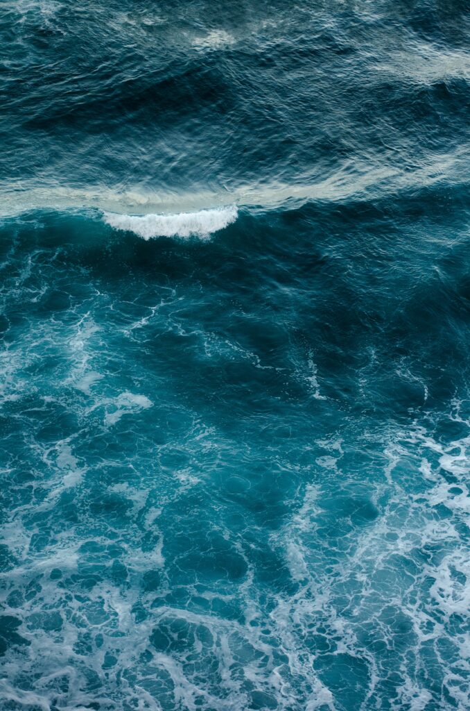 Serene ocean wallpaper with vibrant blue waves and white foam creating a calming backdrop