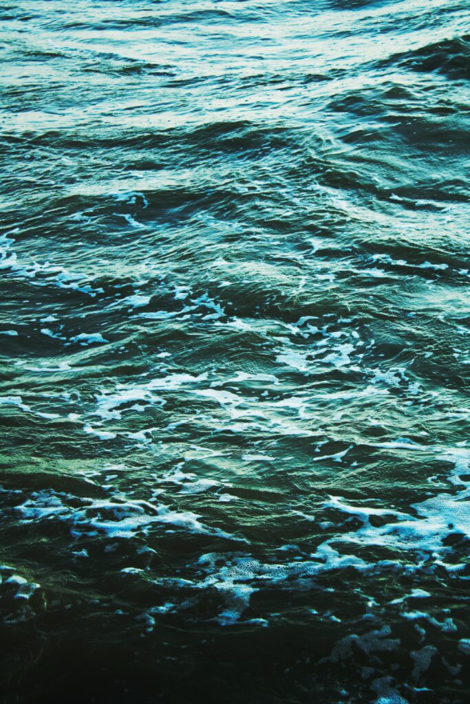 Calming ocean wallpaper with gentle sea waves turquoise ripples and soft white foam background
