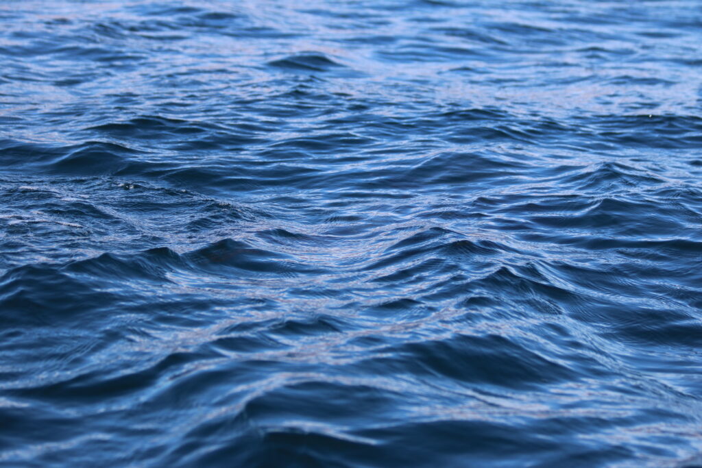 Calming open sea wallpaper with gentle waves and rippling blue ocean water texture background