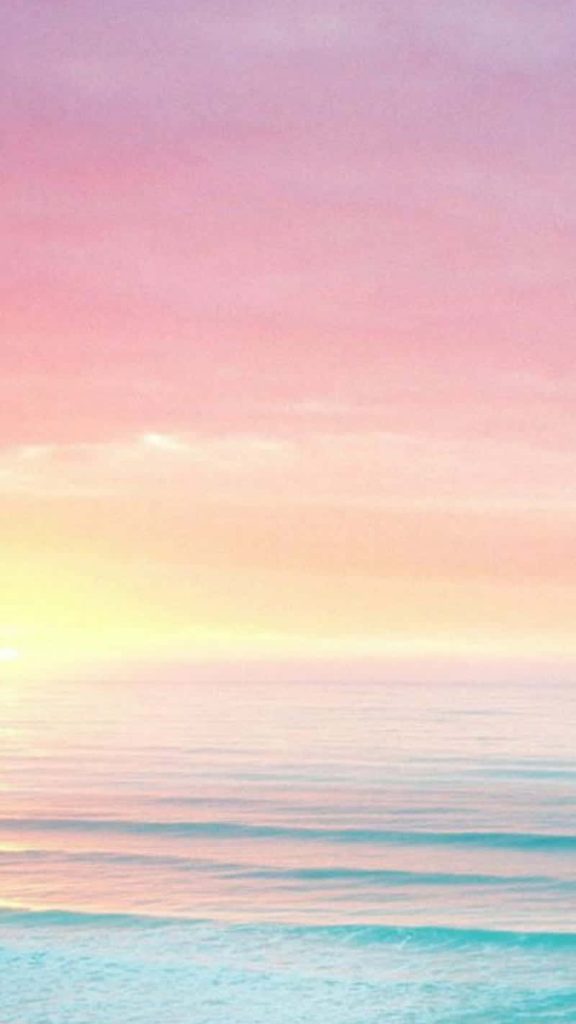 Pastel rainbow ocean wallpaper with soft pinks golden sunlight and tranquil turquoise waves