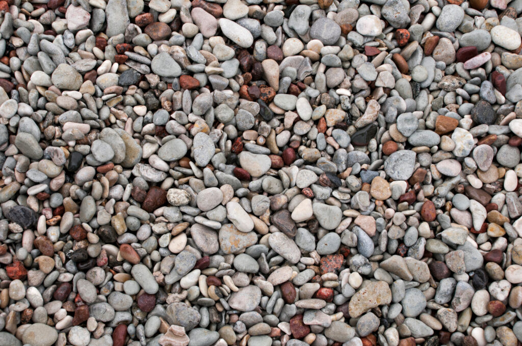 Smooth sea stones and pebbles wallpaper with natural gray beige earth tones calming mosaic texture