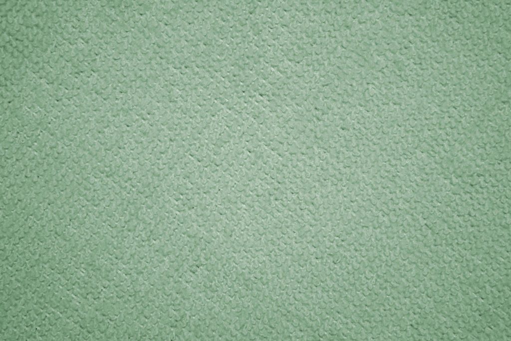 Close-up of sage green textured fabric background with soft loops minimalist wallpaper design