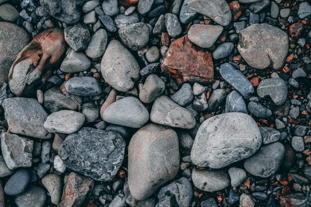 Earth tone sea stones wallpaper with smooth and ribbed textures creating a calming effect