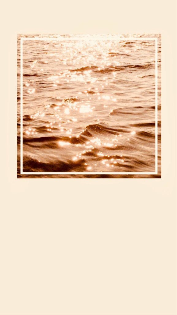 Ocean waves ripple in warm tan sepia tones minimalist aesthetic wallpaper background