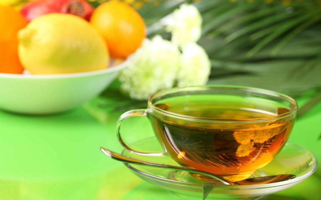 Calming Wallpaper: Glass Tea Cup with Lemon & Soft Greenery Background
