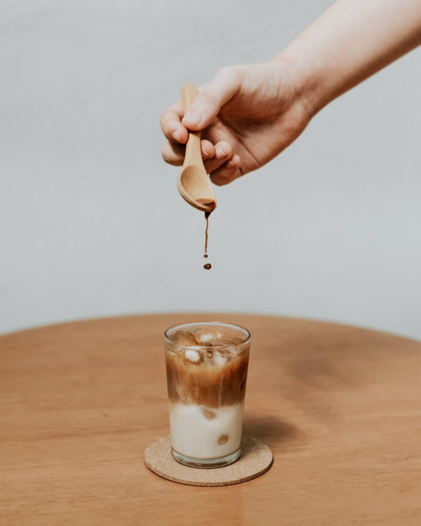 Calming Wallpaper: Hand Holding Wooden Spoon Dripping Coffee