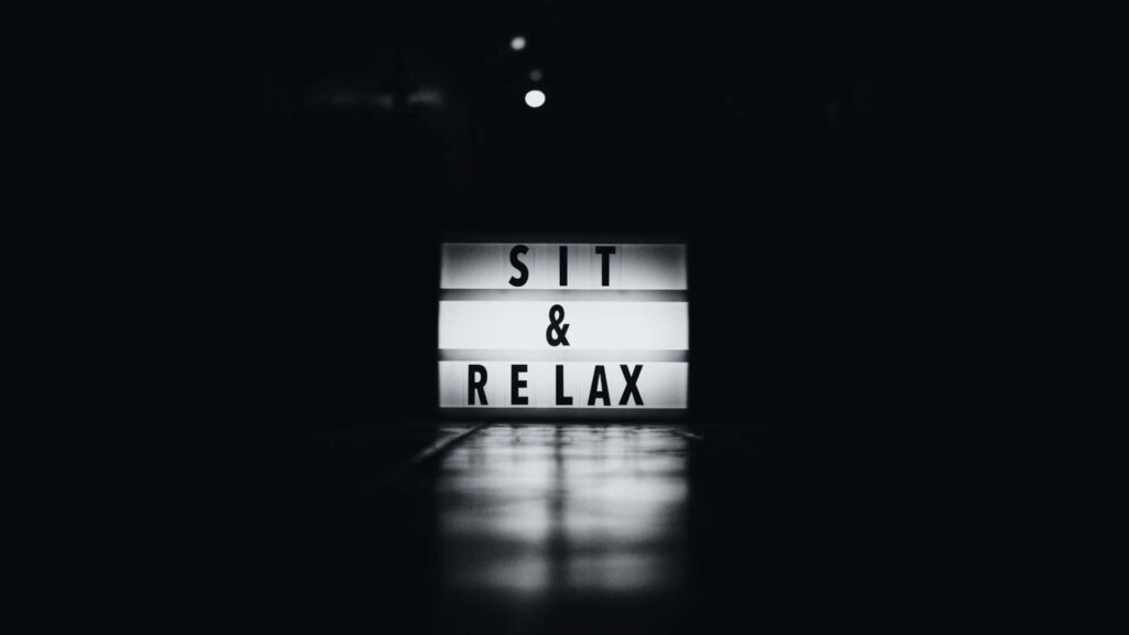 Minimalist Retro Lightbox Wallpaper: SIT & RELAX on Brick Wall