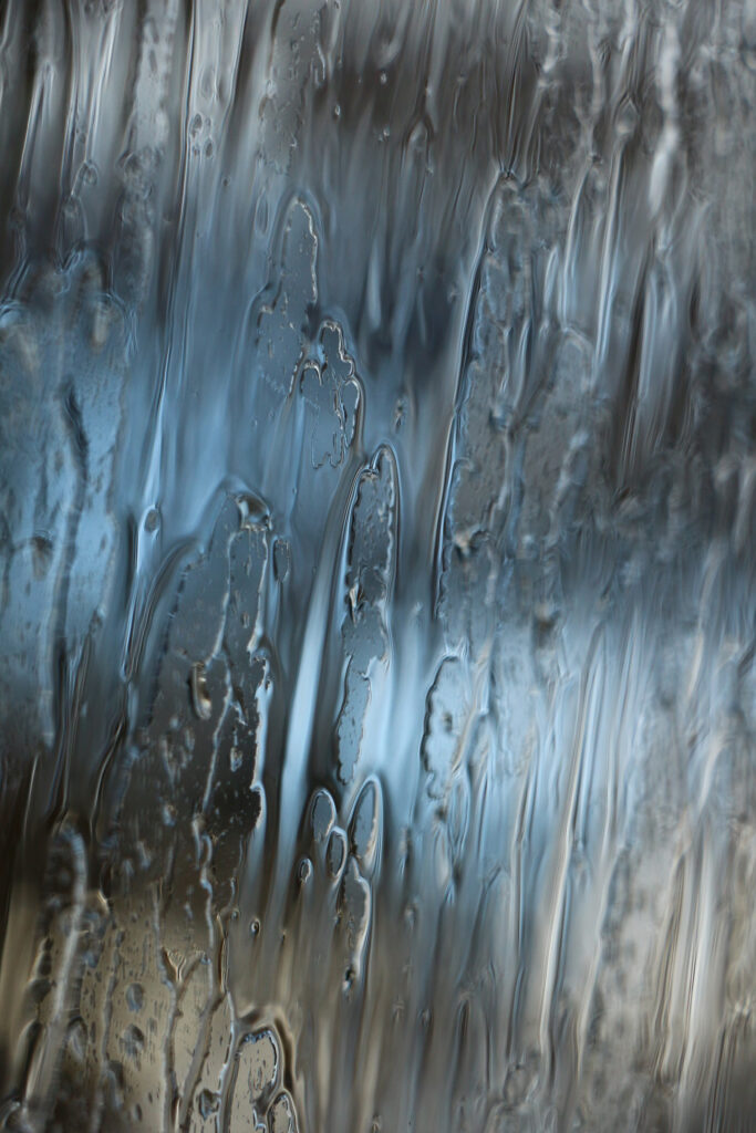 Calming Water Droplets Wallpaper: Blurred Glass Surface Background