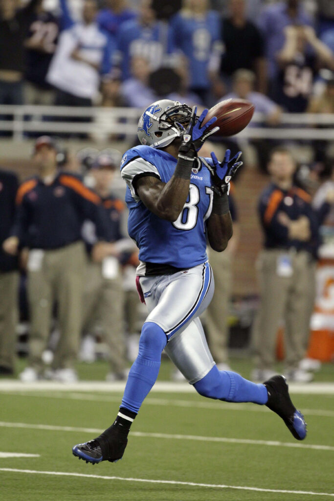 Calvin Johnson Detroit Lions blue silver uniform leaps catching football dynamic stadium wallpaper