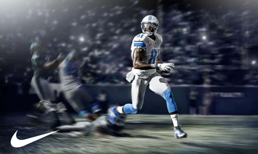 Calvin Johnson Detroit Lions sprinting on vibrant football field with Nike logo and blue tones wallpaper